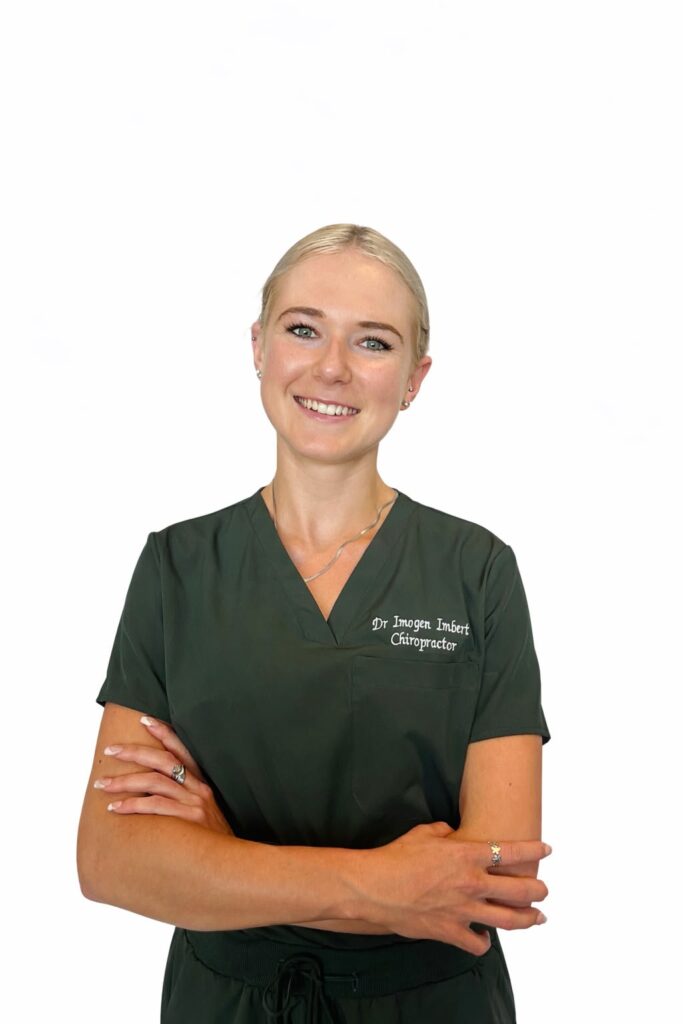 Smiling chiropractor in medical attire.